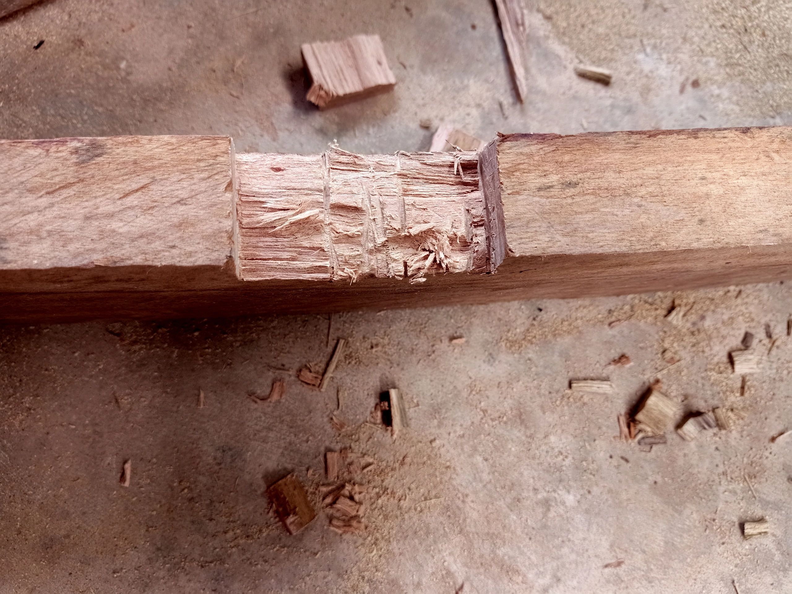 Carpenter shaping wood by hand