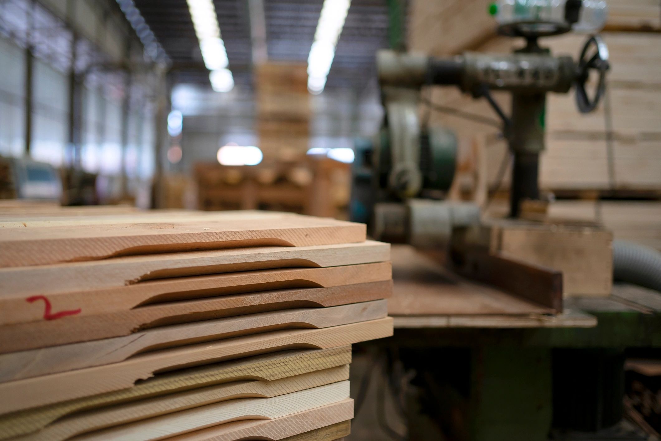 Craftsmen working with wood materials in a production setting