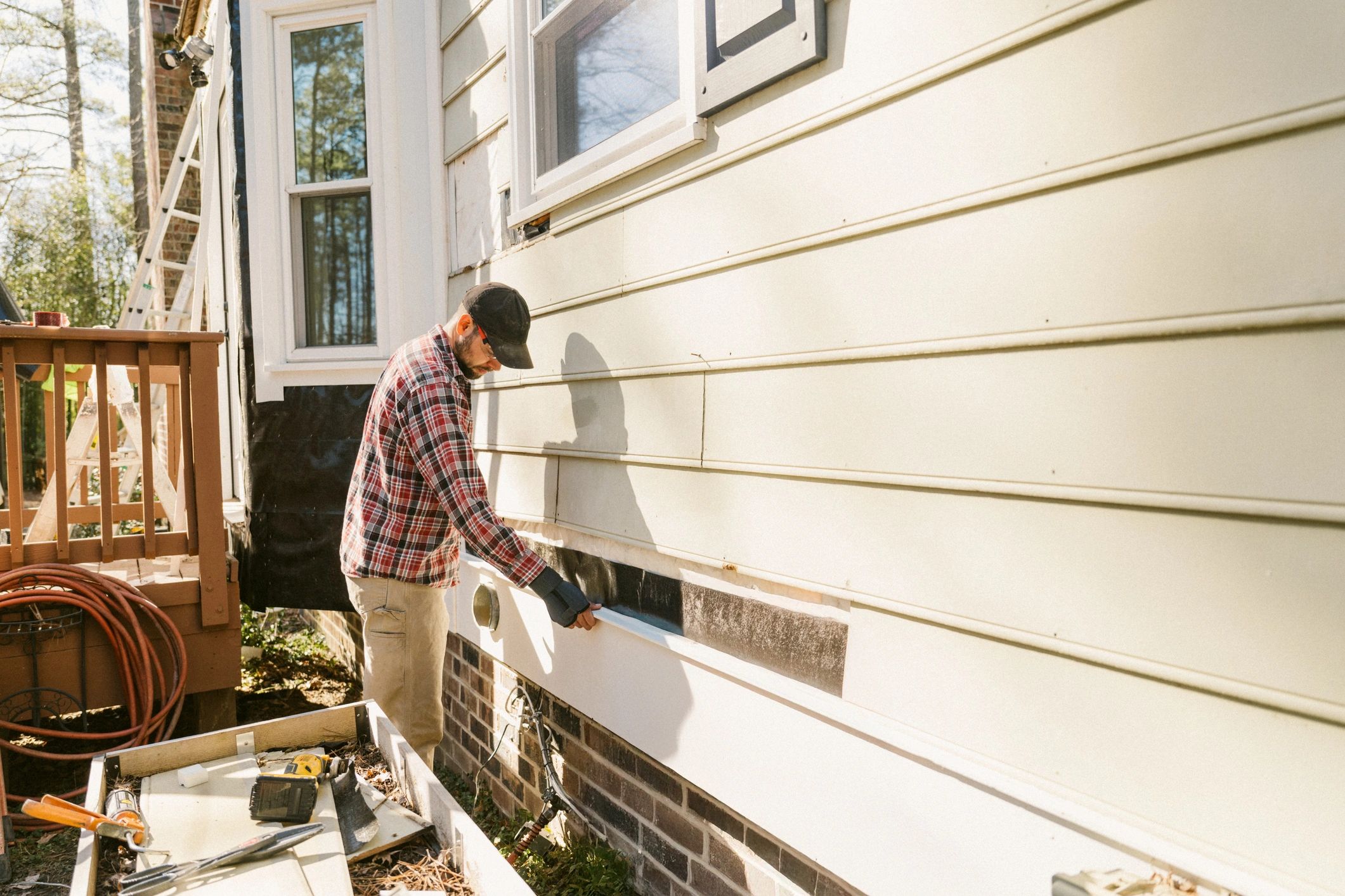 Worker repairing exterior wood trim