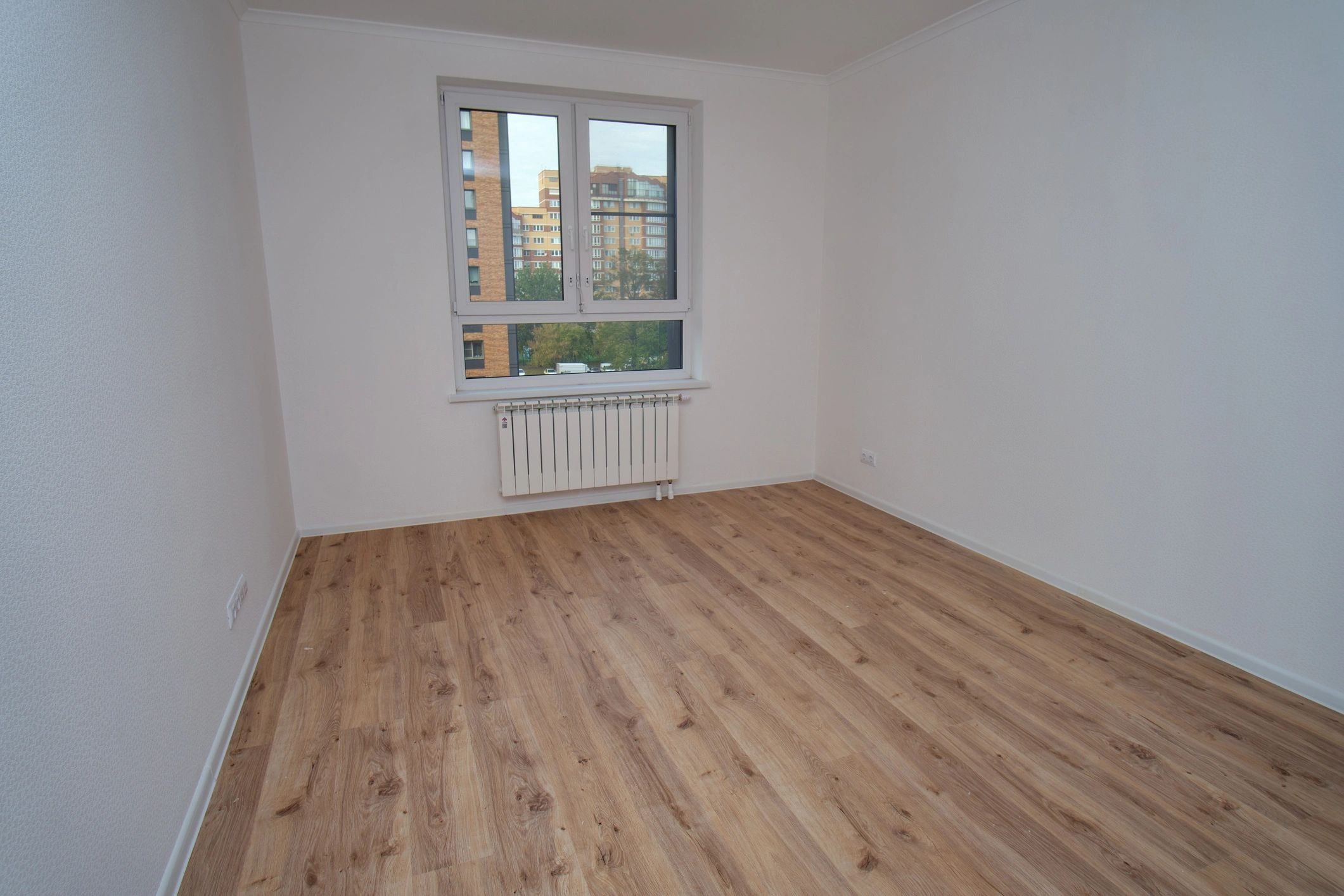 Bright interior room with clean trim and wood flooring
