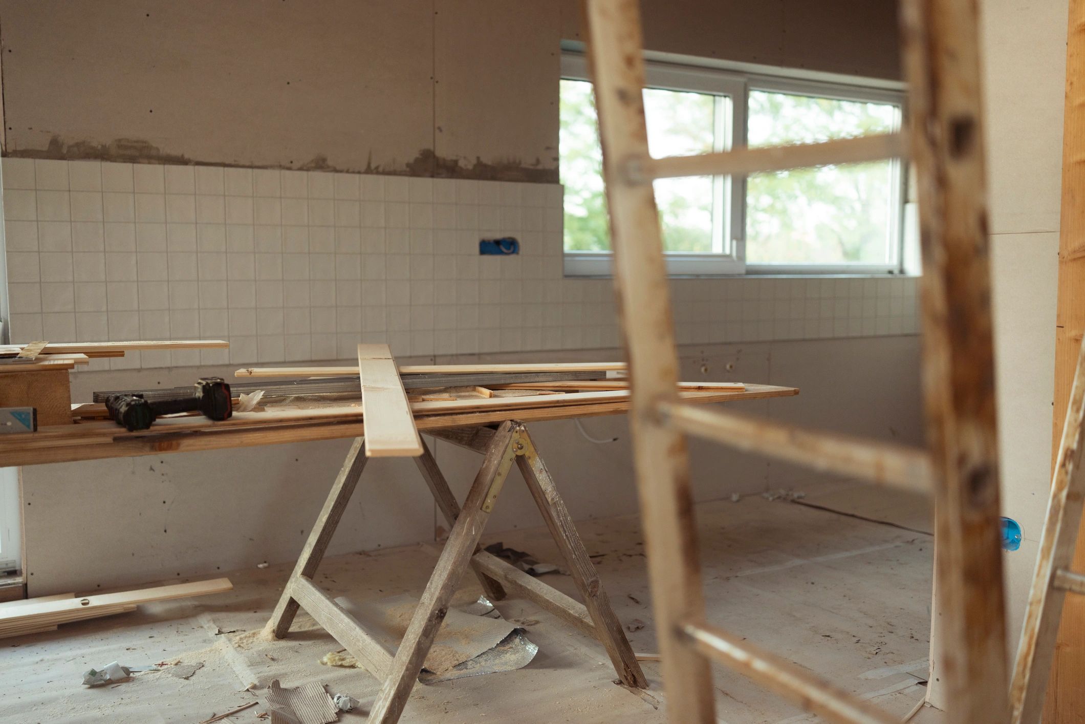 Interior residential construction area showing carpentry repair and framing conditions